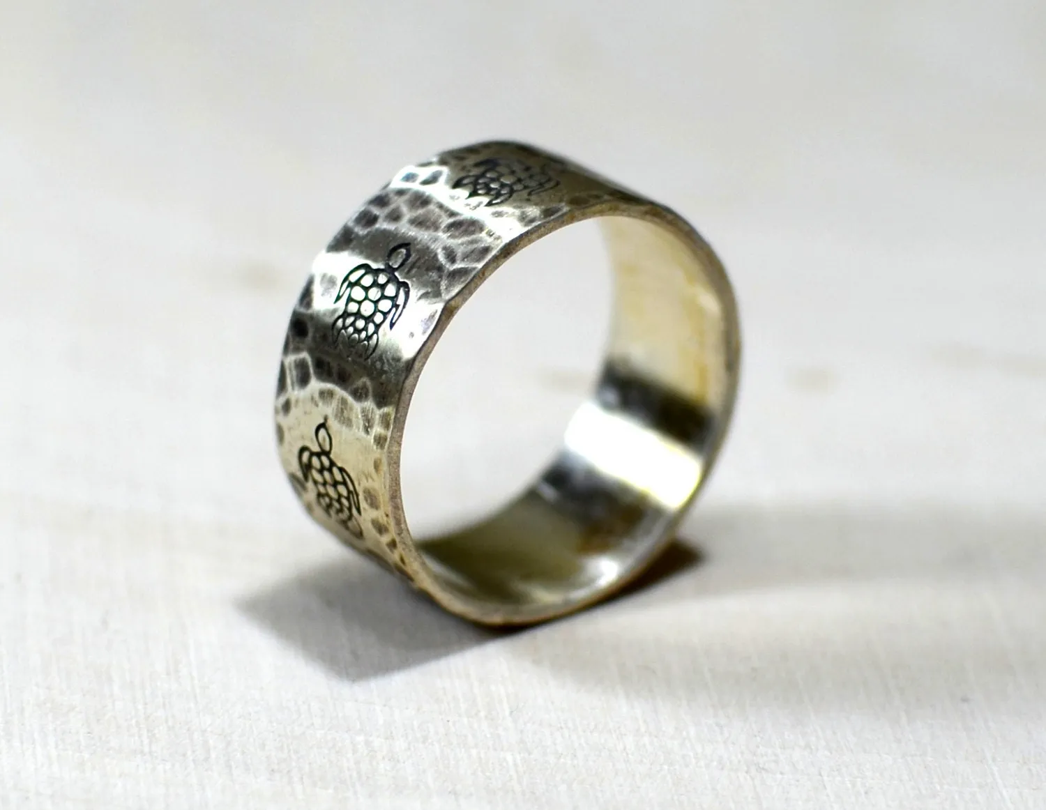 Sterling silver ring with rustic sea turtles and hammered patterning