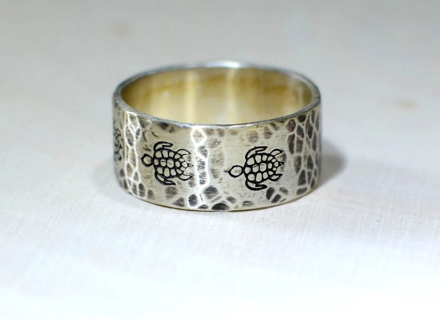 Sterling silver ring with rustic sea turtles and hammered patterning